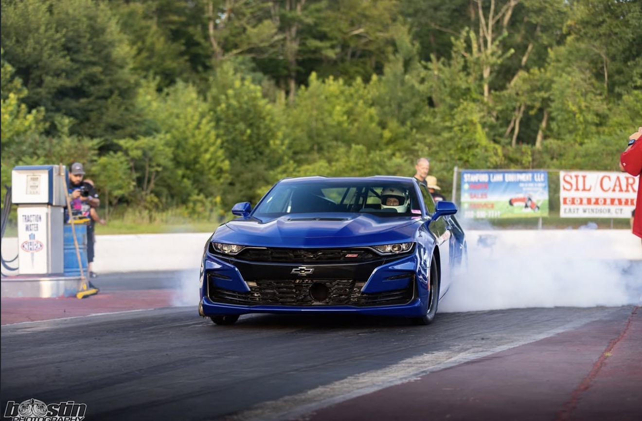 Blue Chevrolet Camaro performing a burnout